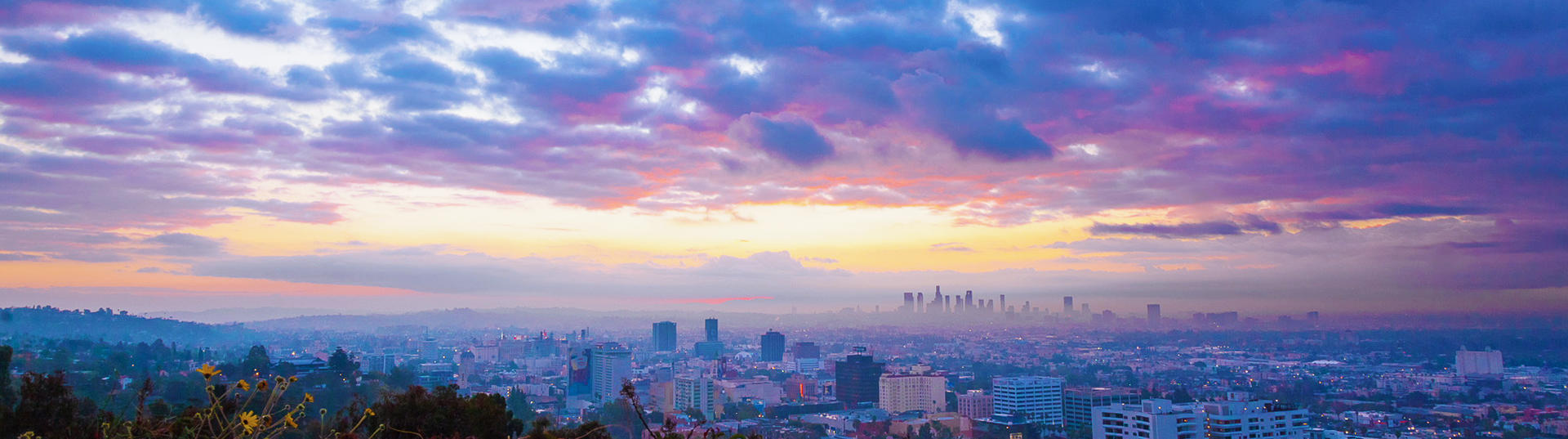 Skyline with sunrise behind clouds