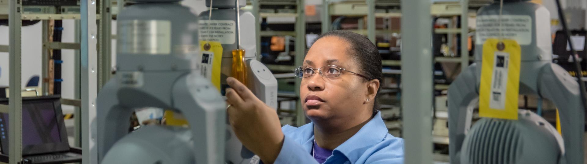 Woman inspecting tag on product in warehouse