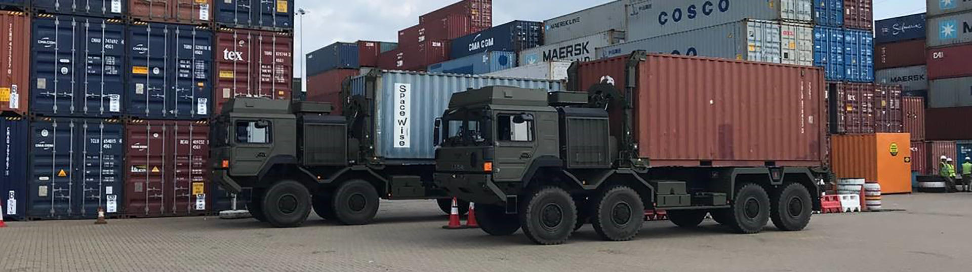 2 trucks with shipping containers