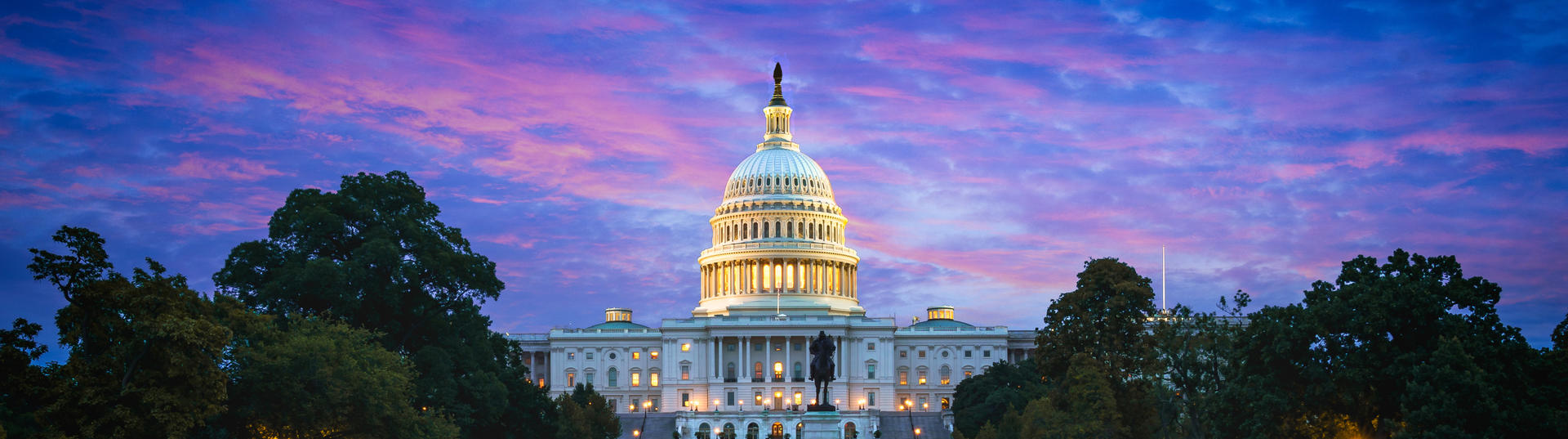 Capitol building with colorful sunset behind