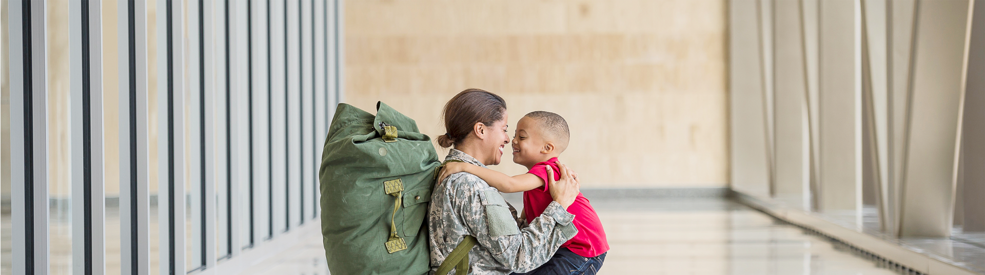 woman in uniform holding son