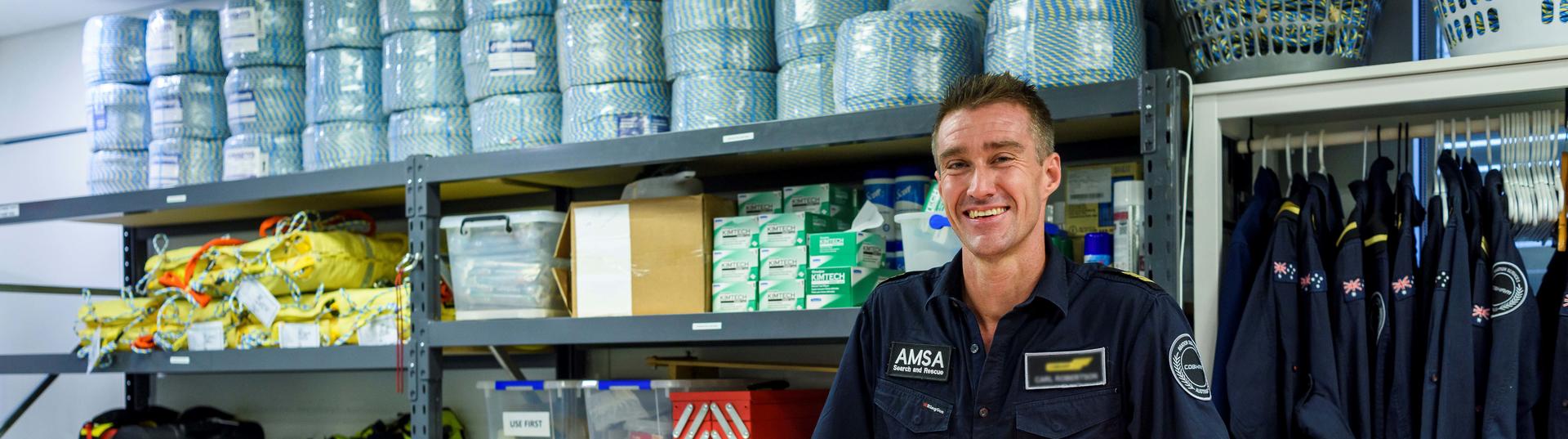 Man standing in supply room smiling
