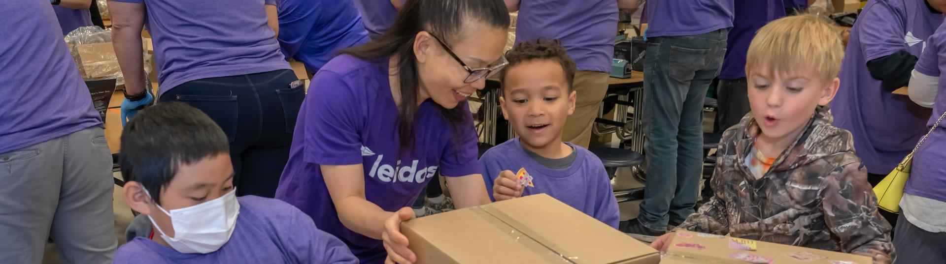 Children packing meals for a generosity feeds event.