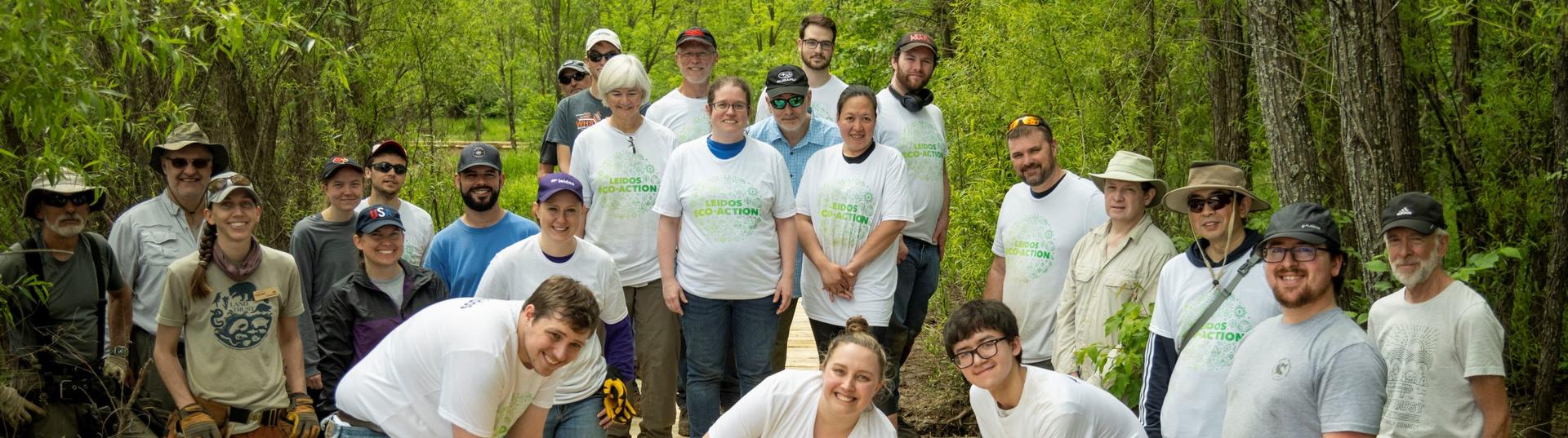 Leidos employees building a boardwalk for access to a nature preserve.
