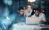 Cropped shot of three young business people working together on a laptop