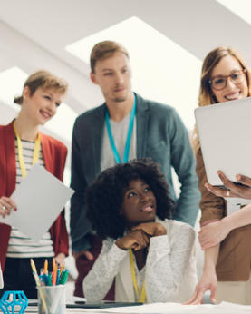 Group of employees around a laptop