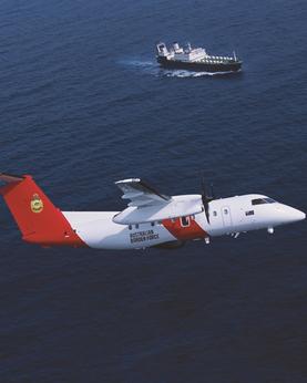 Plane flying over ocean with ship in the background