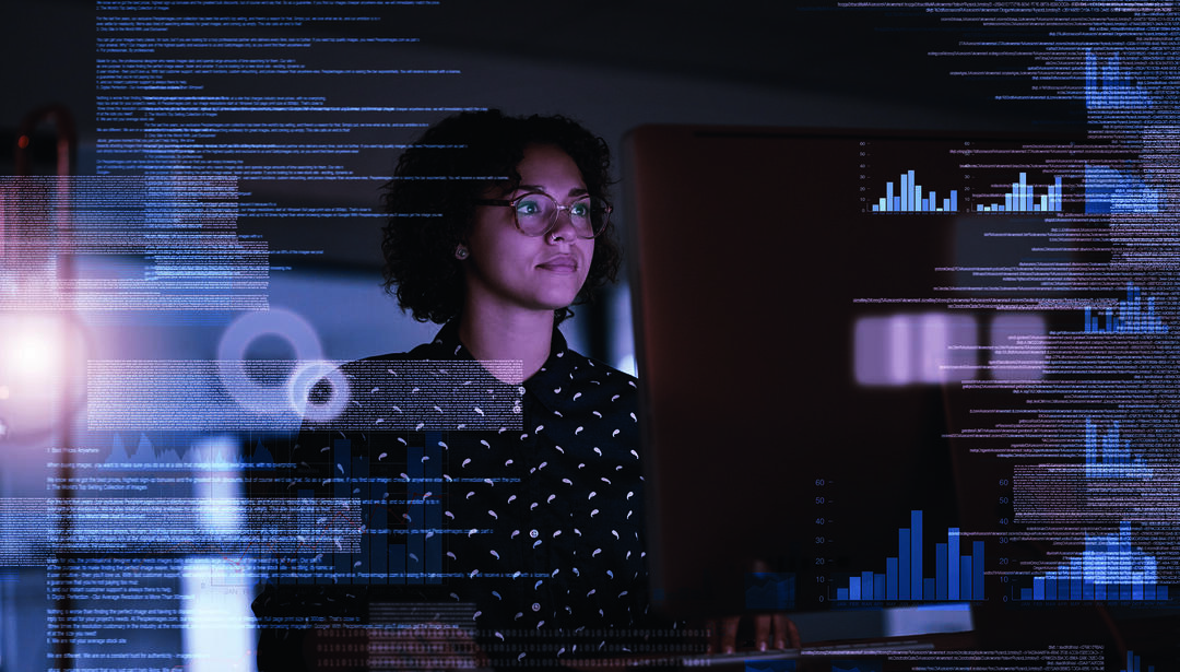 Woman at computer with graphical charts