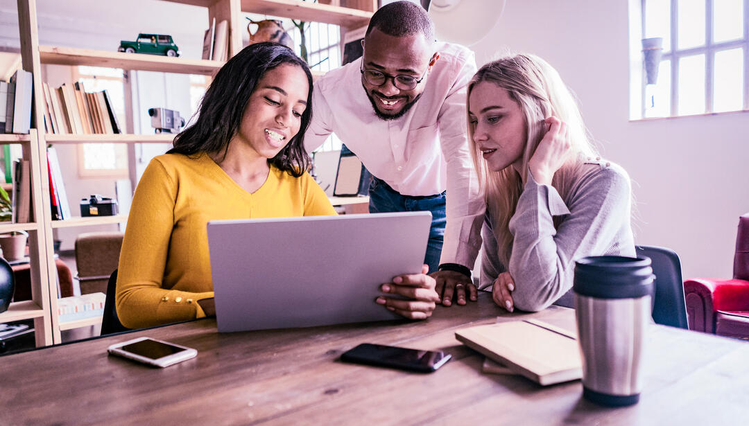 group of employees looking at screen