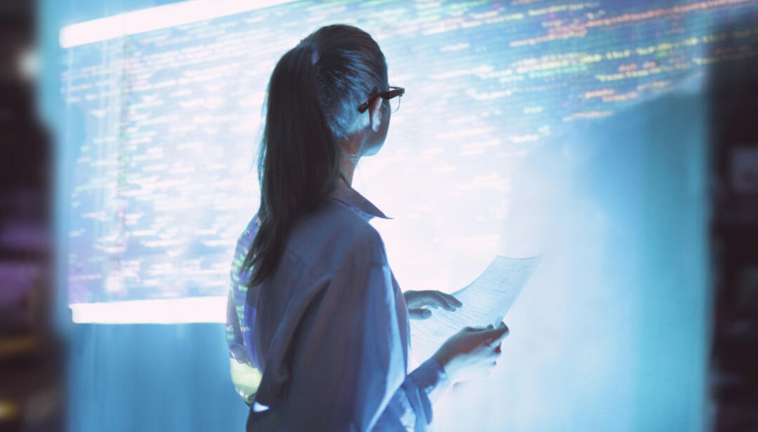 A woman looks at a screen