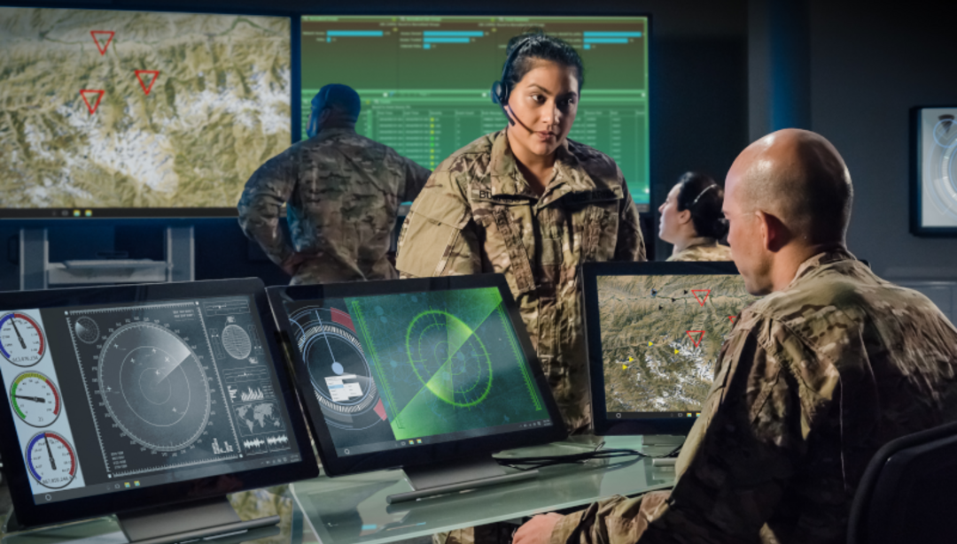 Military members looking at screens for warfighter insight