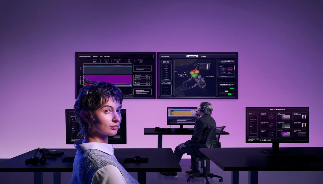 woman in front of large computer bays displaying data