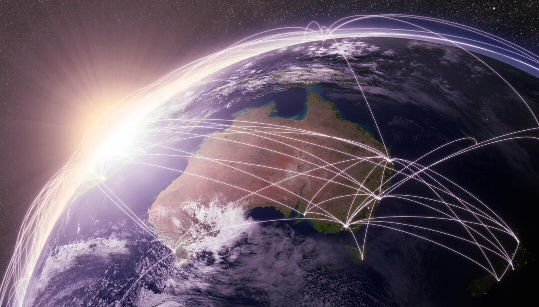 A global with Australia and the sun shining over the horizon