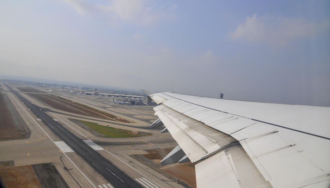 airplane wing over runway