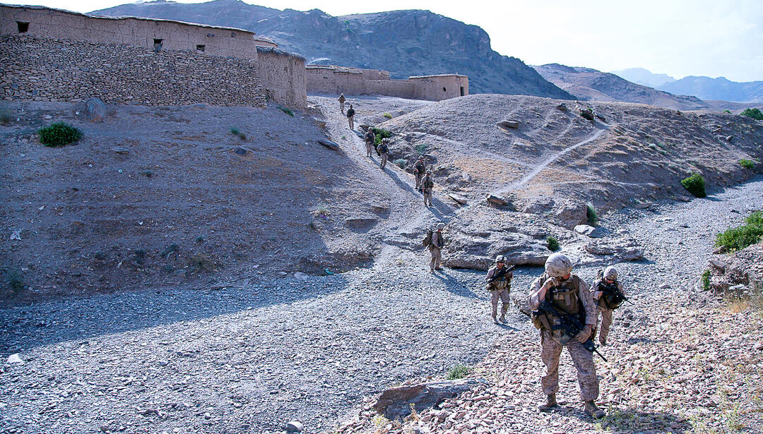 Soldiers walking through desert