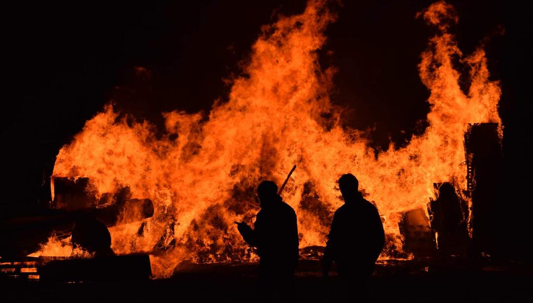 Wildfire with silhouette of firefighters
