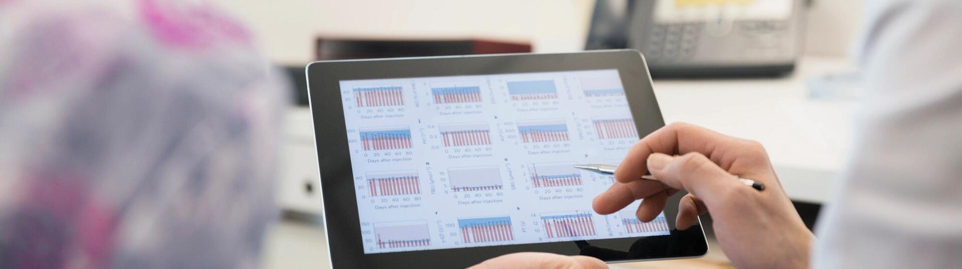 Two people working on tablet