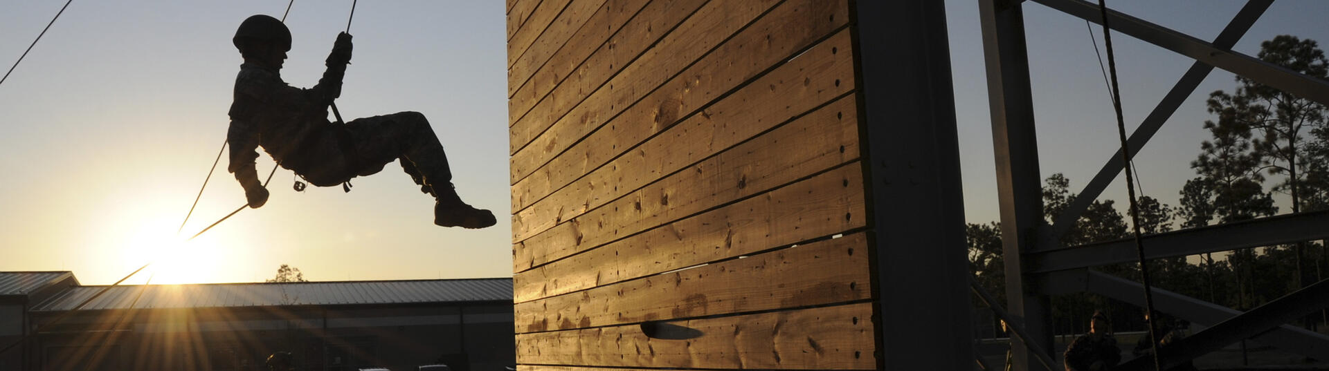 Person scaling obstacle course wall