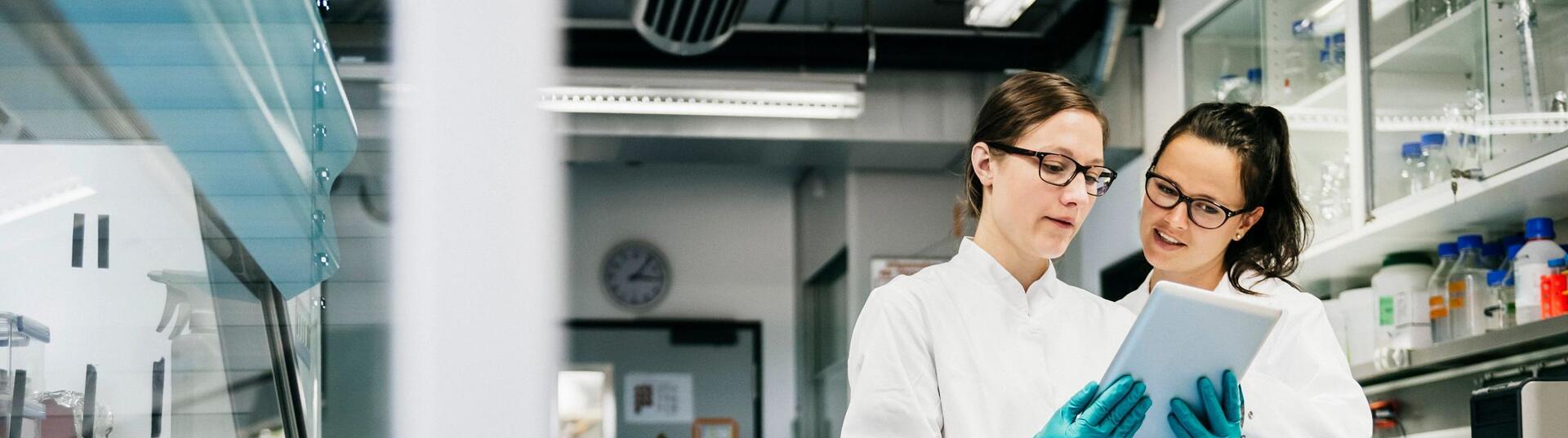 Two scientist reviewing a document