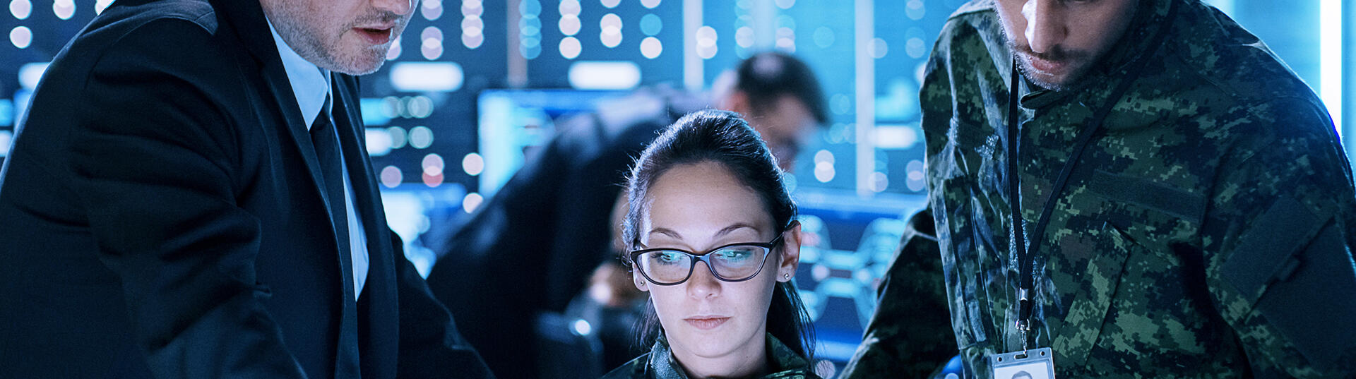 three coworkers looking at a monitor