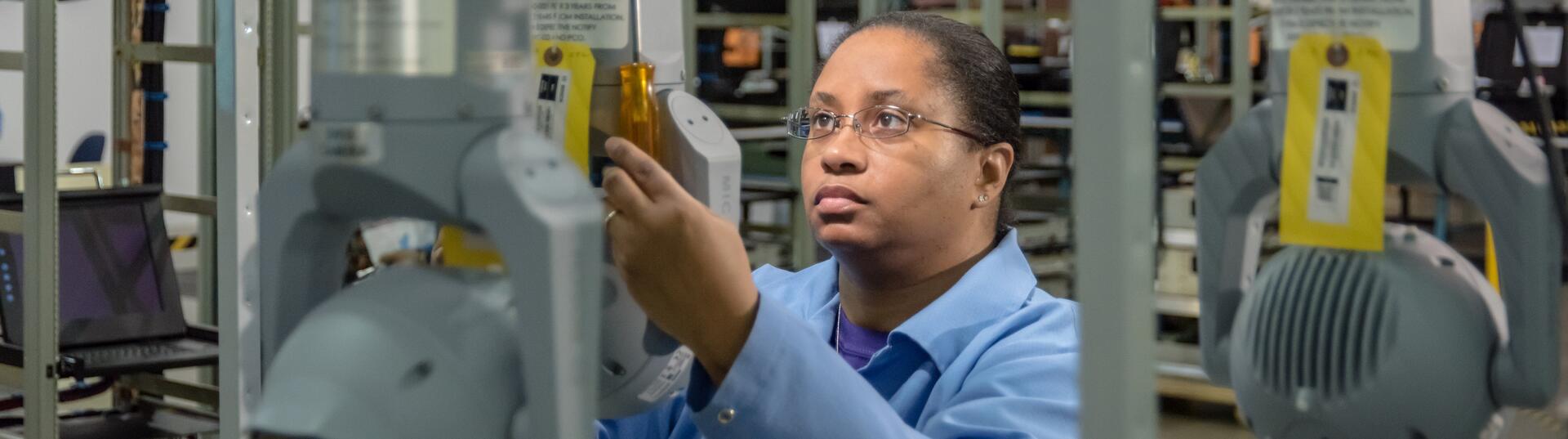 Woman inspecting tag on product in warehouse