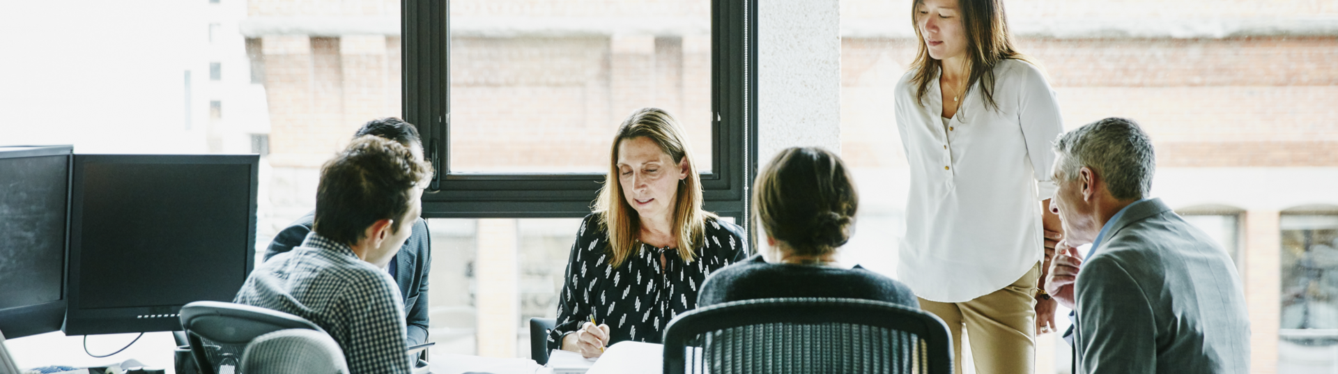 Group collaborating in office