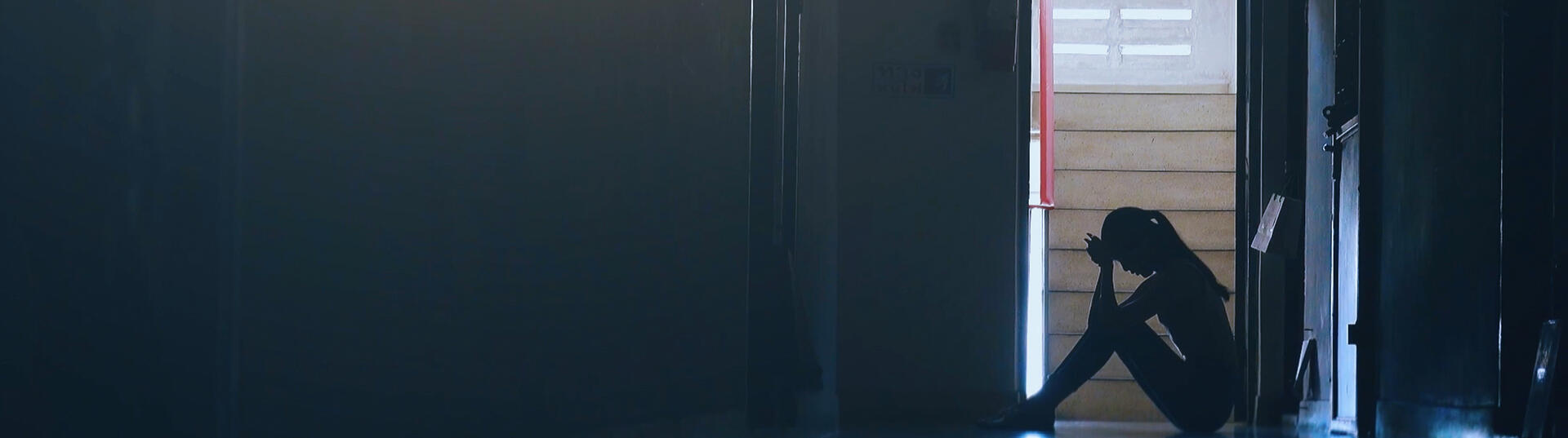 girl sitting in doorway with mental health