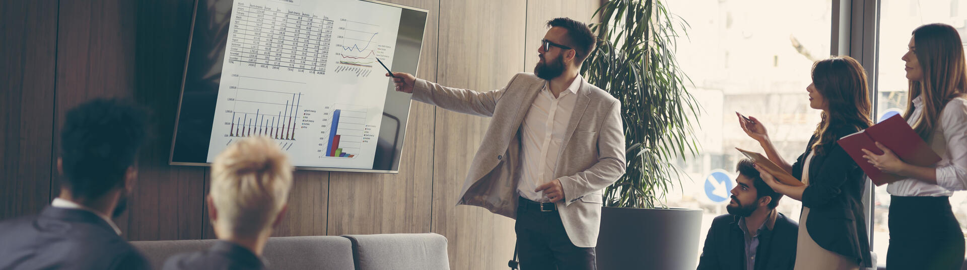 Team sat and stood watching a presentation