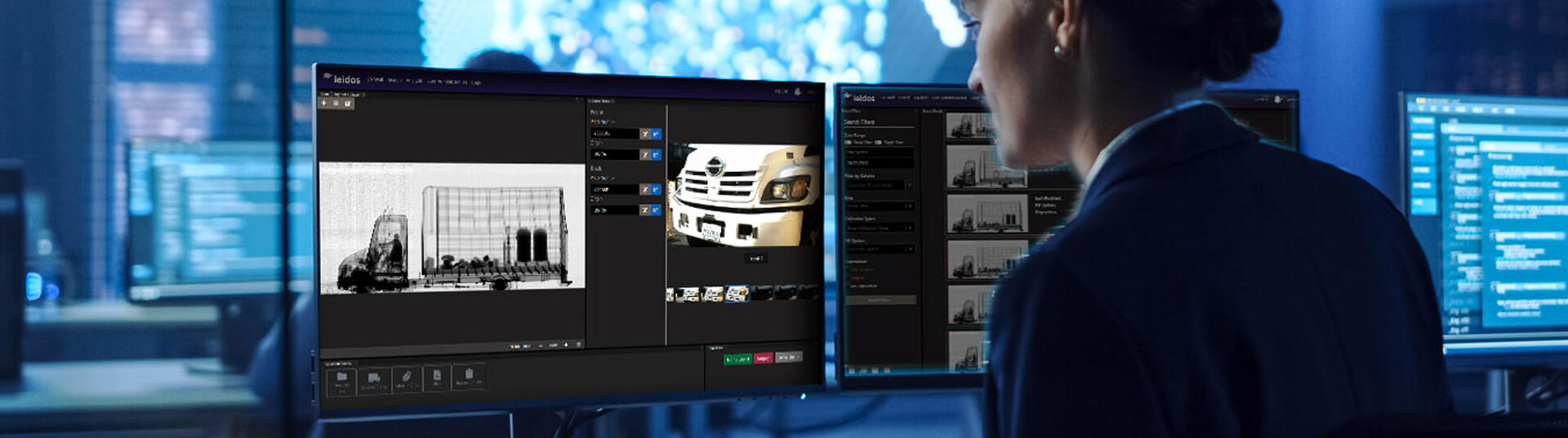 women sitting at computer monitors