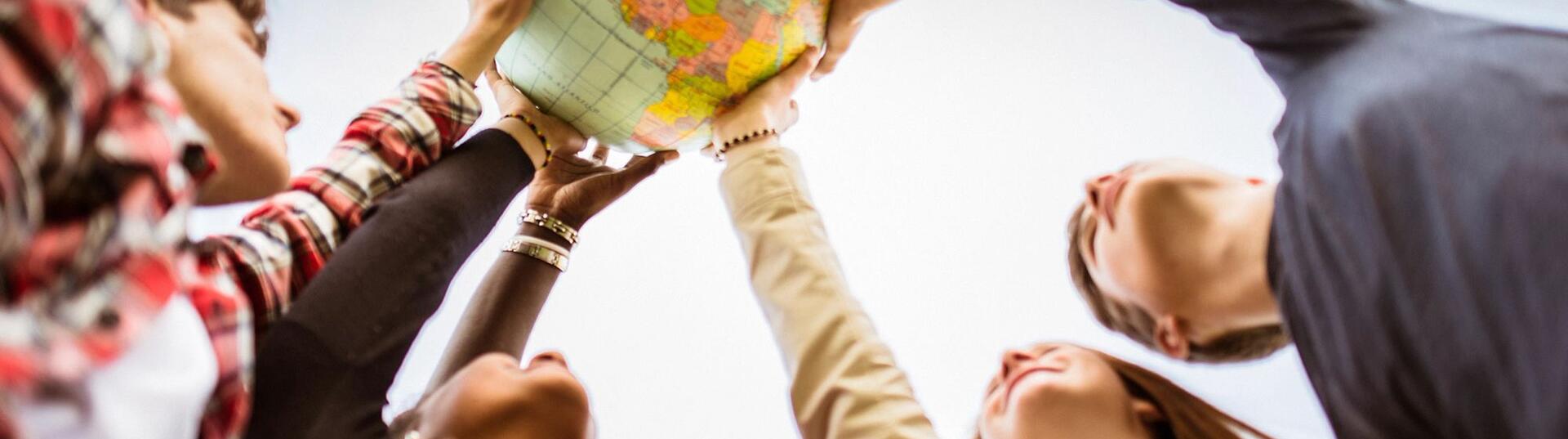 Peoples hangs on a globe in unity