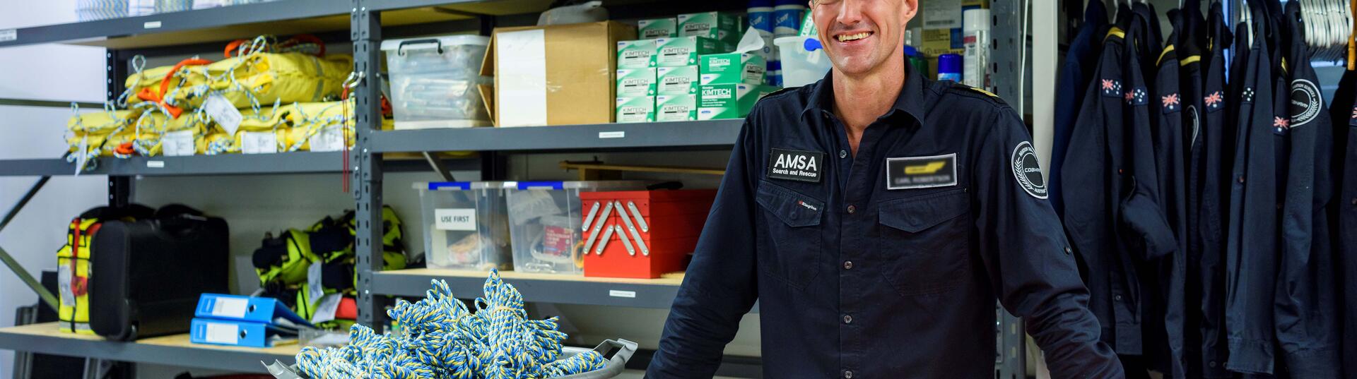 Man standing in supply room smiling