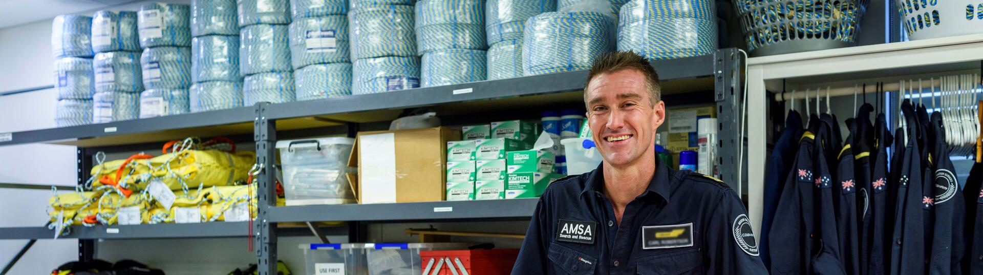 Man standing in supply room smiling