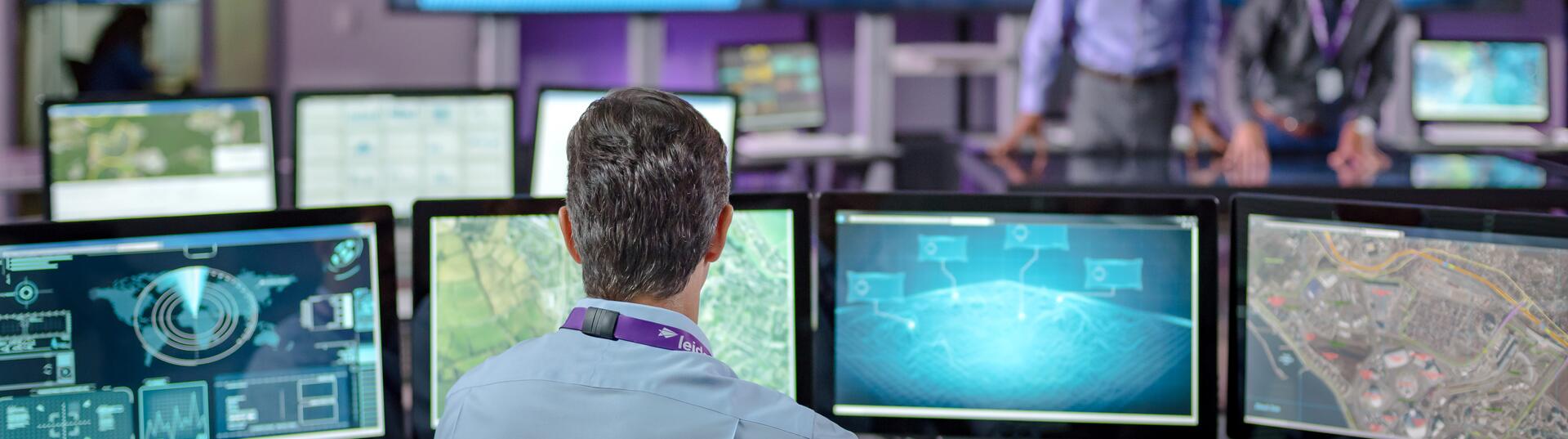 People working an office full of screens