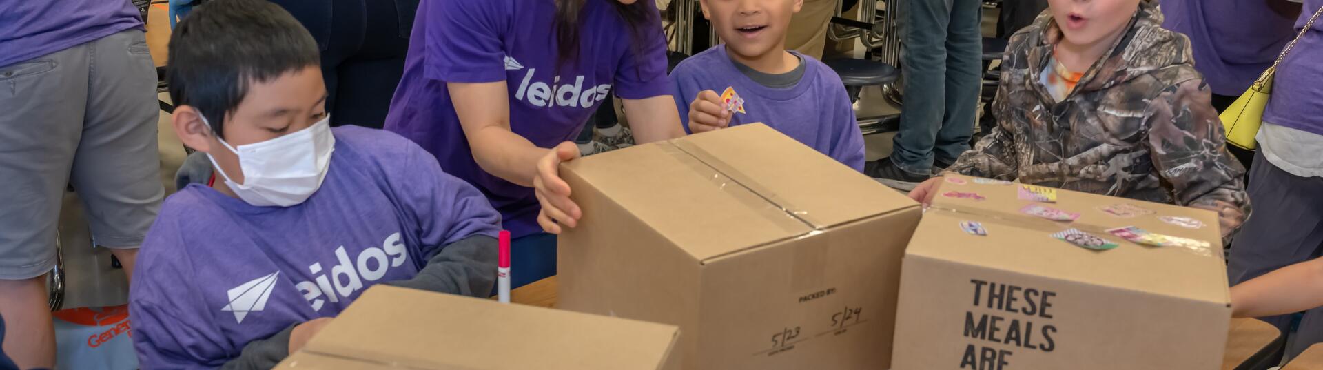 Children packing meals for a generosity feeds event.