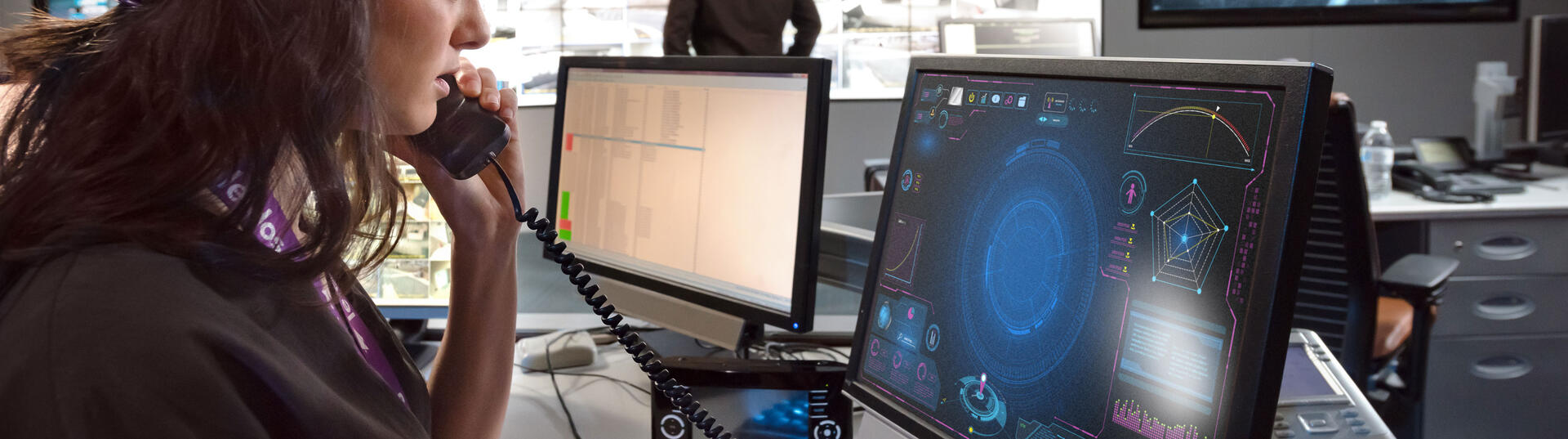 Women talking on phone while at her computer