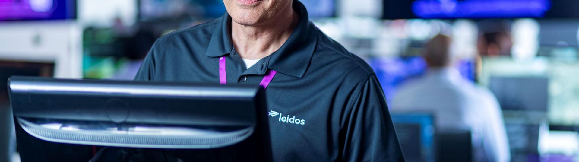 man standing at computer mointor