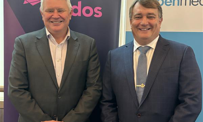 Two men standing in front of banners