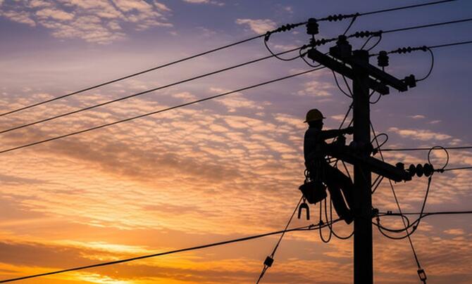 Lineman climbing a distribution pole