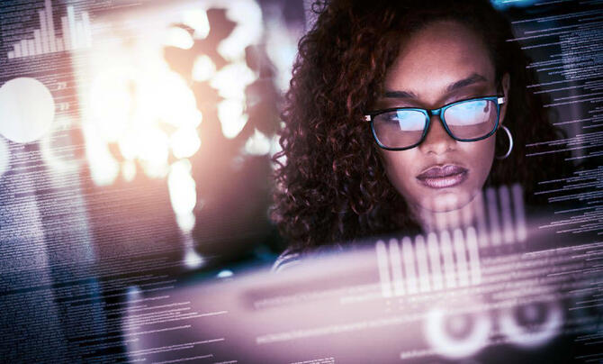 Woman working in front of a computer screen