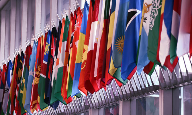 A long row of different country flags displayed next to each other at the Department of State