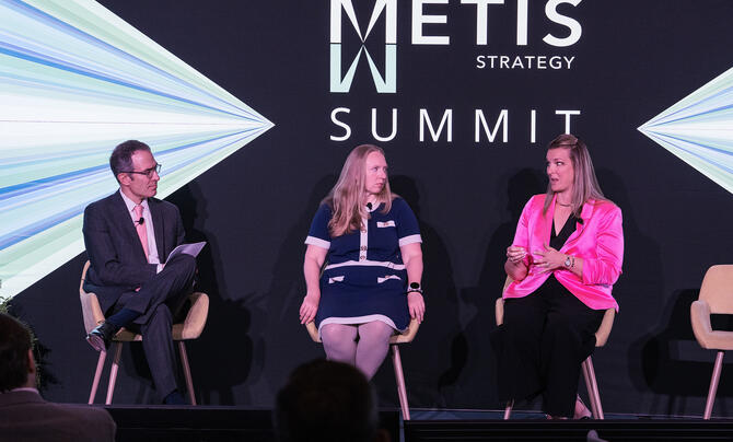 A panel of speakers participates in a discussion at the Metis Strategy Summit, sharing insights on leadership and technology strategy.