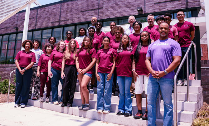 Group of high school students, educators, and Leidos representatives pose outside North Carolina Central University during a STEM program focused on artificial intelligence and emerging technologies.