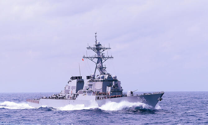 Arleigh Burke Destroyer ship on water with light purple filter