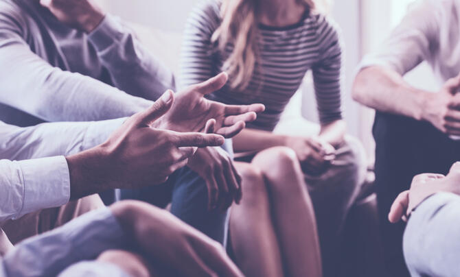 Close-up of the hands of a group of people