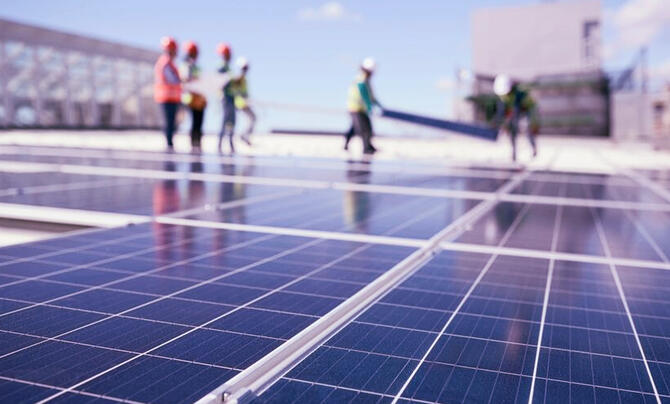 Energy workers laying solar panels