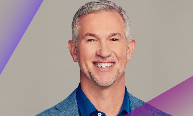 A portrait of Jeff McElfresh - smiling in a blue dress shirt, open collar, and blue sport coat