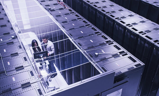 Two professionals in a data center