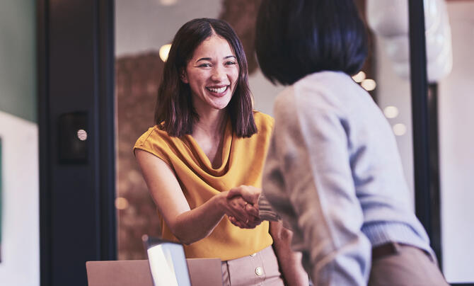Two people meeting and shaking hands
