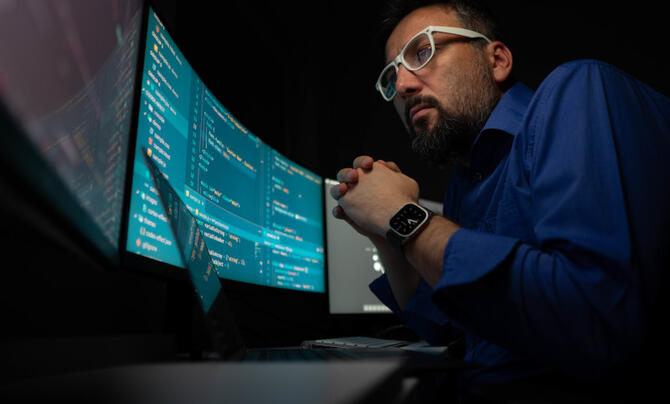 Man looking at screen of code