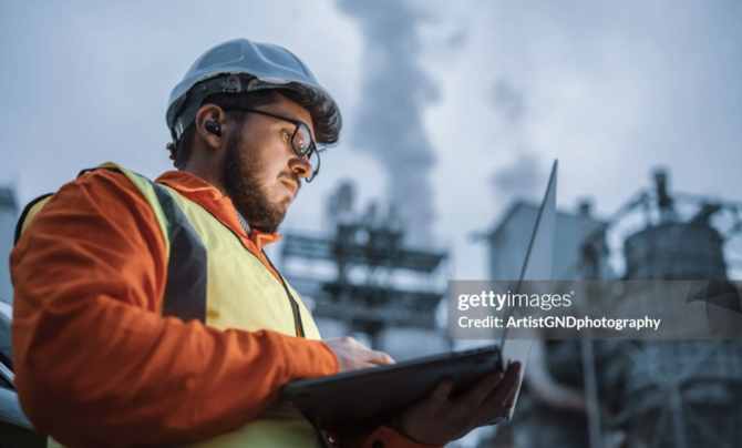 https://www.gettyimages.com/detail/photo/serious-handsome-engineer-using-a-laptop-while-royalty-free-image/1310818458?searchscope=image%2Cfilm&adppopup=true An engineer in high visibility safety gear, using a laptop outside a power plant